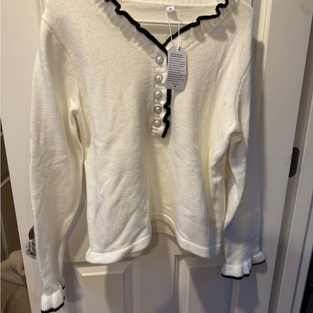 Elegant White Cardigan with Black Trim and Pearl Buttons